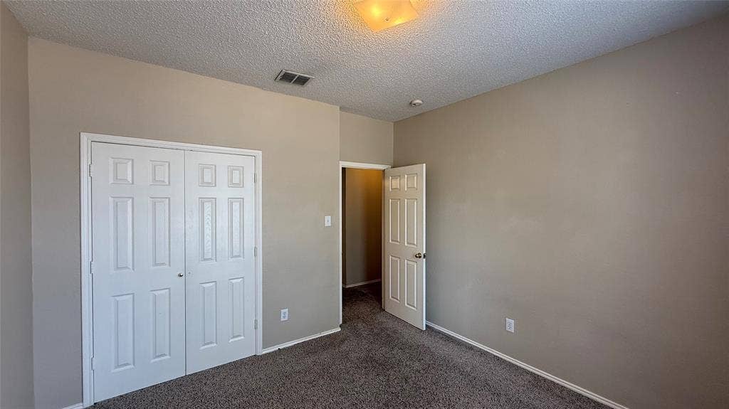 1433 Winterwood Drive, Allen, TX 75002 Neutral wall paint, textured ceiling, carpeted flooring, and a flush-mount light fixture