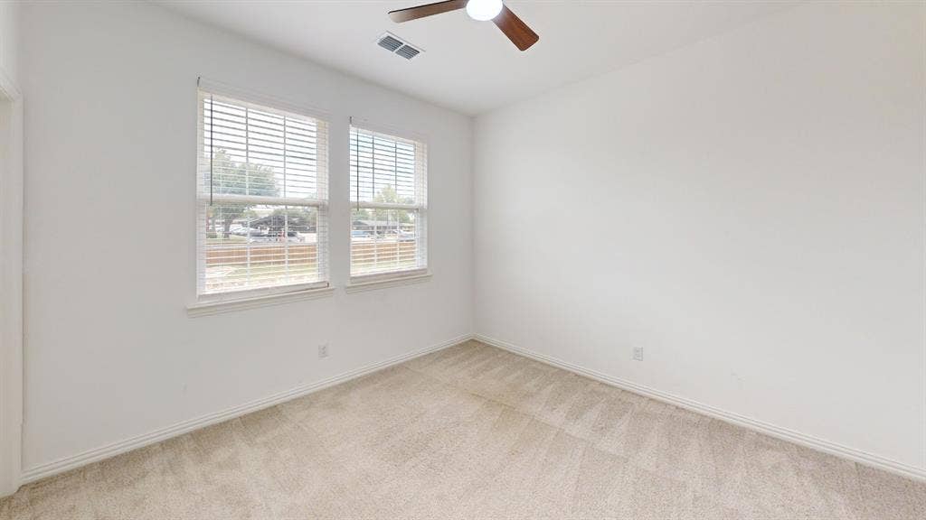 3285 Dover Drive, McKinney, TX 75069 White walls, light-toned carpet, two windows with blinds, and a ceiling fan