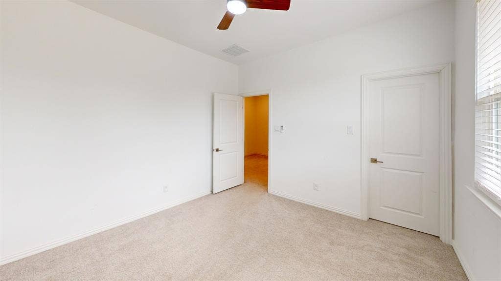 3285 Dover Drive, McKinney, TX 75069 Carpeted flooring, white walls, two-panel interior doors, and a ceiling fan