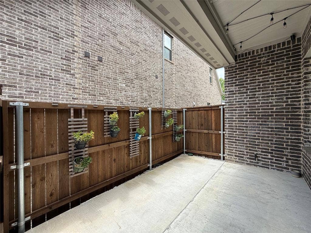 3285 Dover Drive, McKinney, TX 75069 Patio featuring a concrete surface, wood fence, and string lighting