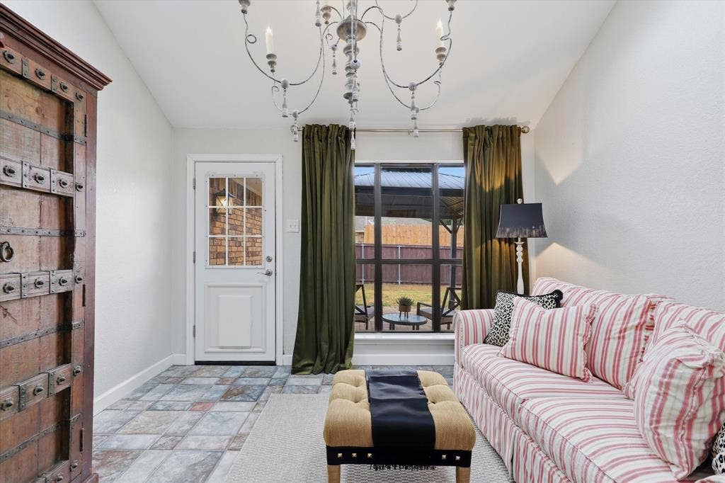 Charming sunroom provides additional living space with backyard access—perfect for a sitting room, playroom or home office.