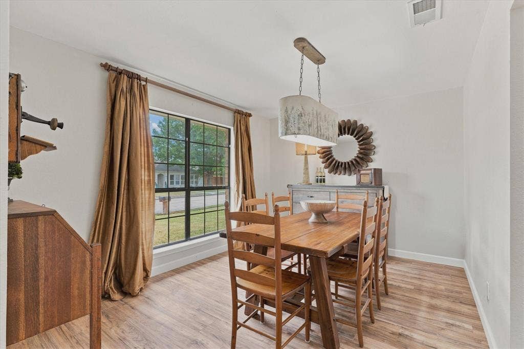 Spacious dining room offers plenty of room for entertaining and a large window overlooking the front yard.