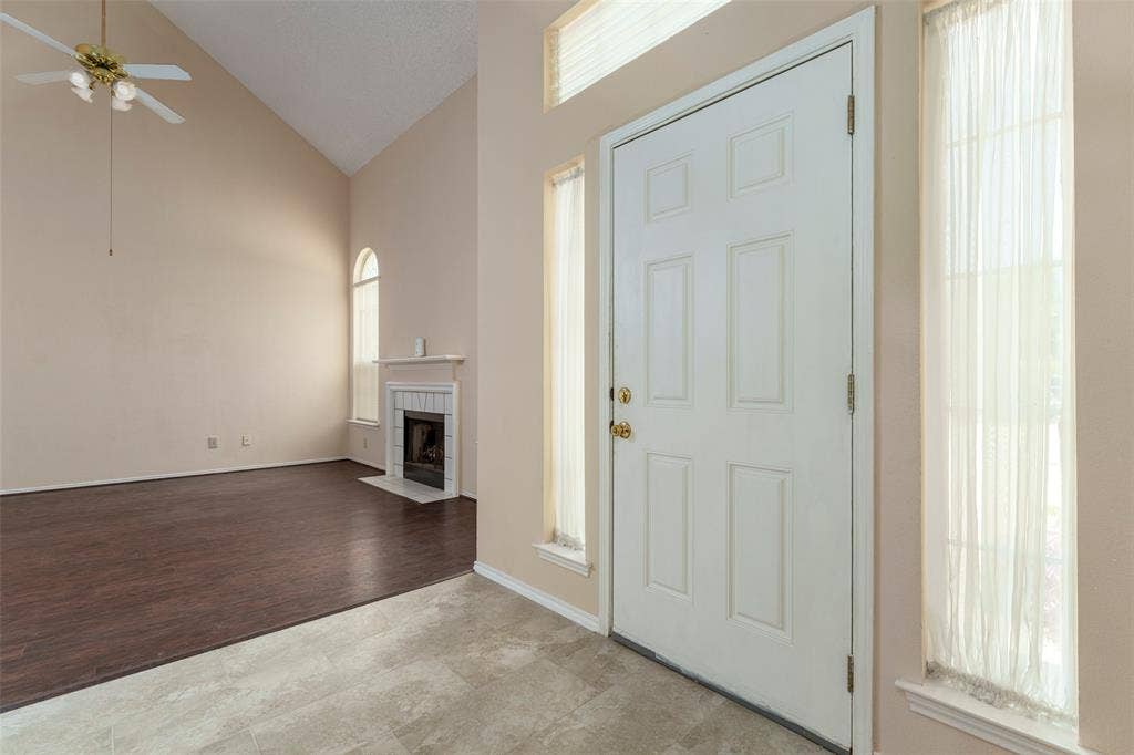 4500 Fargo Drive, Grand Prairie, TX 75052 Vaulted ceiling, ceiling fan, fireplace with mantel, arched window, wood-finish flooring
