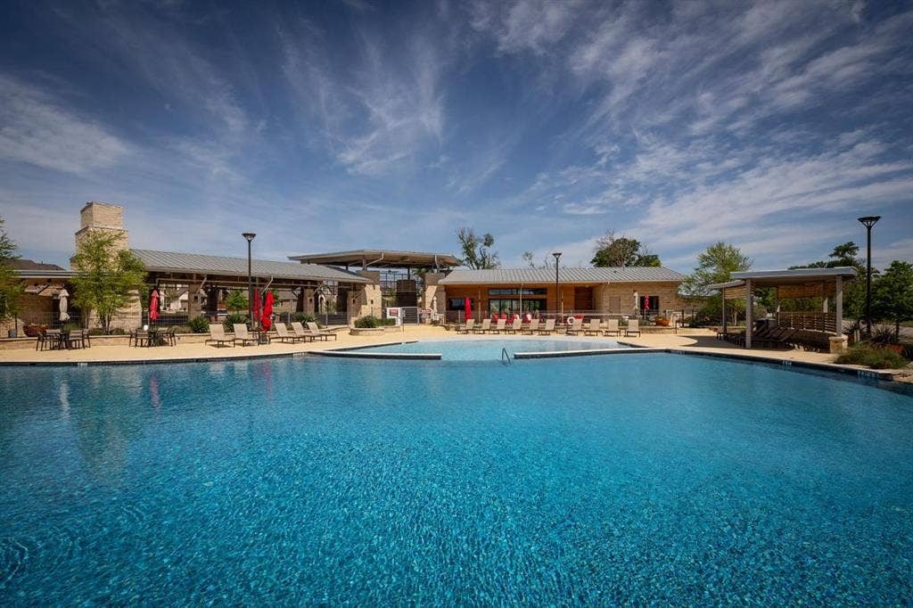7421 San Jacinto Trail, McKinney, TX 75071 Trinity Falls photo from their website showing one of the many amenities, trails, pools, gym and parks.
