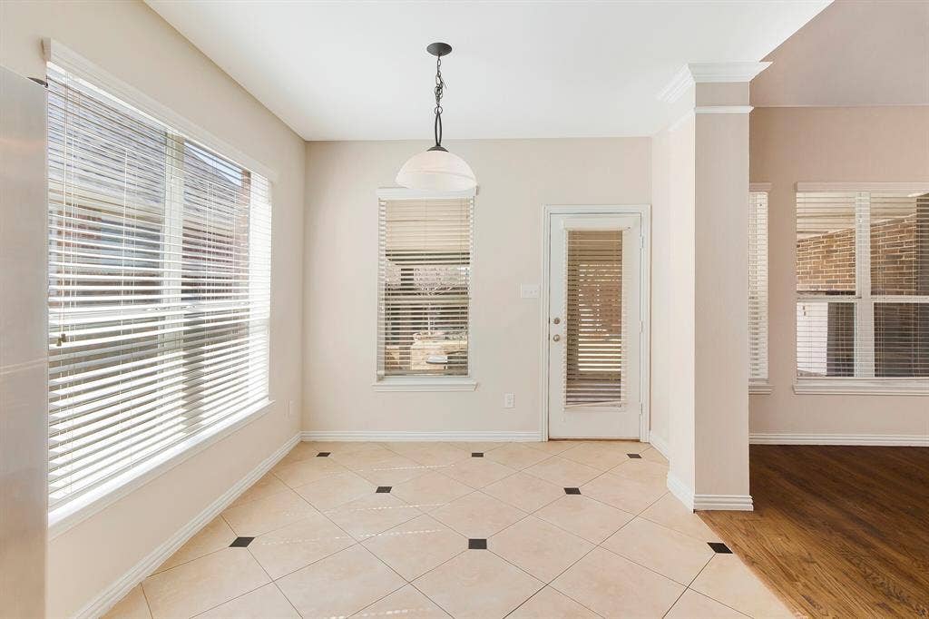 4908 Rushden Road, McKinney, TX 75070 Tiled flooring with dark accent squares, multiple windows with blinds, a glass-paneled door, and a suspended ceiling fixture