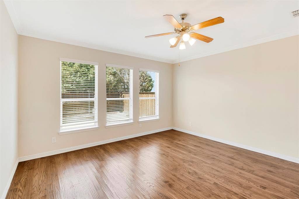 4908 Rushden Road, McKinney, TX 75070 Wood-finish flooring, multiple windows with blinds, ceiling fan with integrated lighting, and crown molding