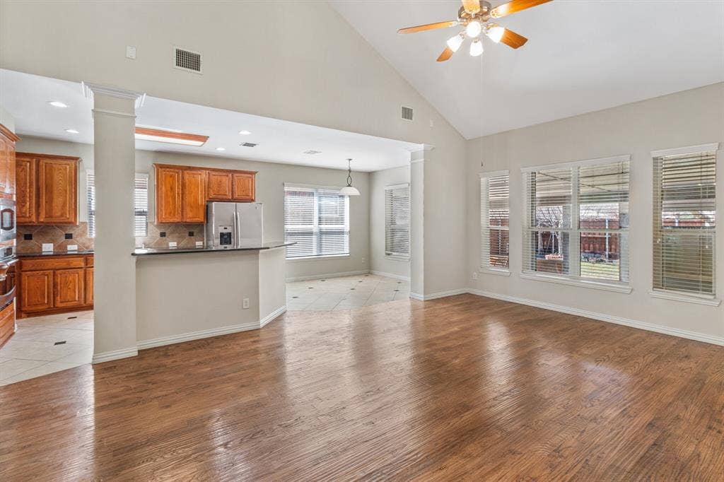 4908 Rushden Road, McKinney, TX 75070 Wood-finish flooring with vaulted ceilings and a ceiling fan
