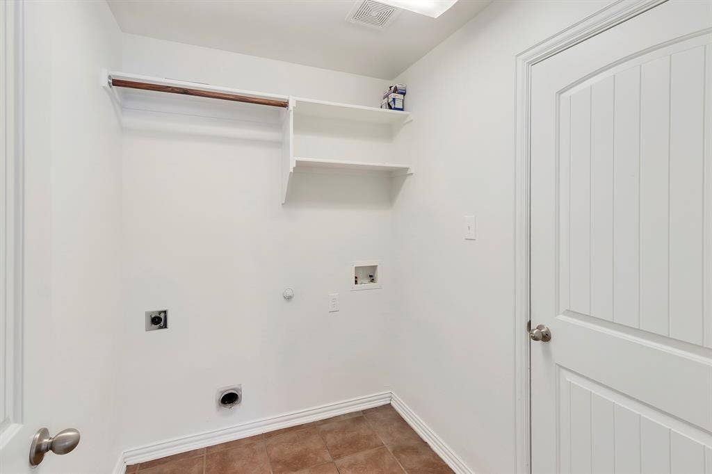 4908 Rushden Road, McKinney, TX 75070 Laundry area featuring a hanging rod, two built-in shelves, and a tile floor