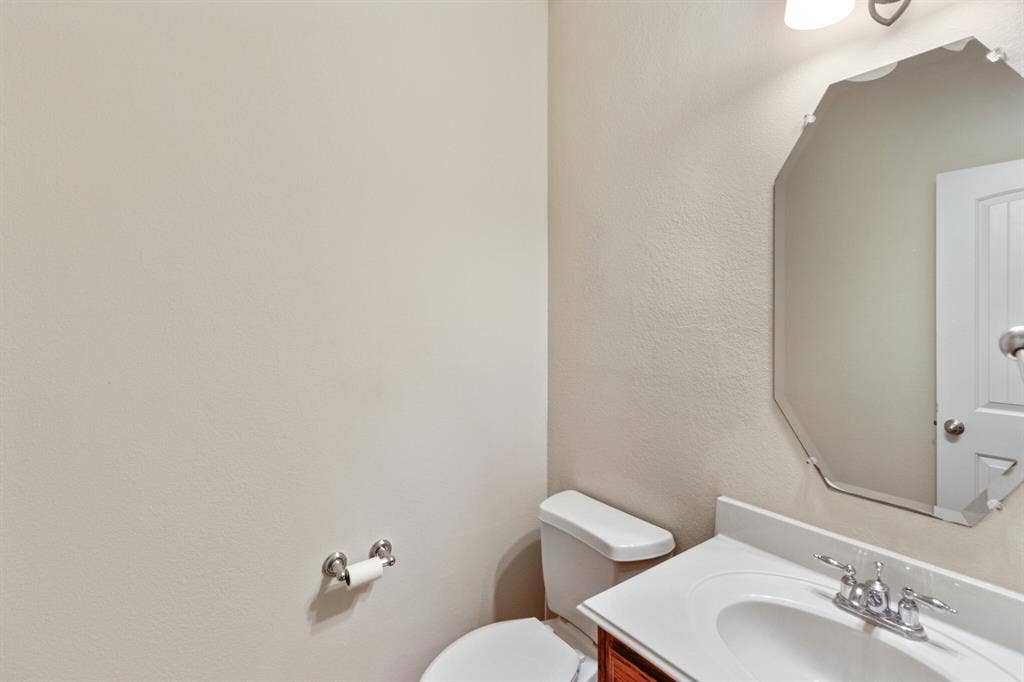 4908 Rushden Road, McKinney, TX 75070 White vanity with integrated sink, chrome faucet, and wood-finish cabinetry
