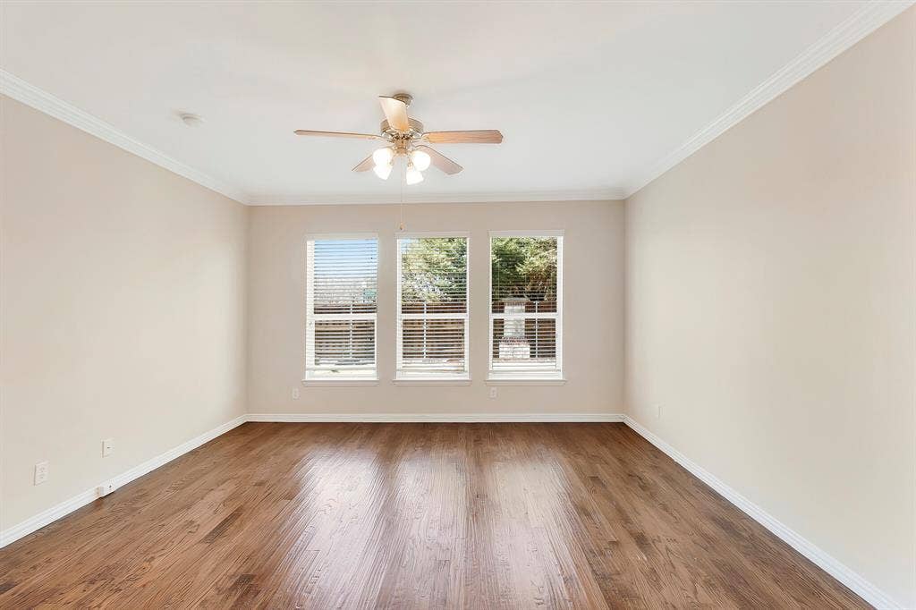 4908 Rushden Road, McKinney, TX 75070 Wood-finish flooring, crown molding, ceiling fan, and multiple windows