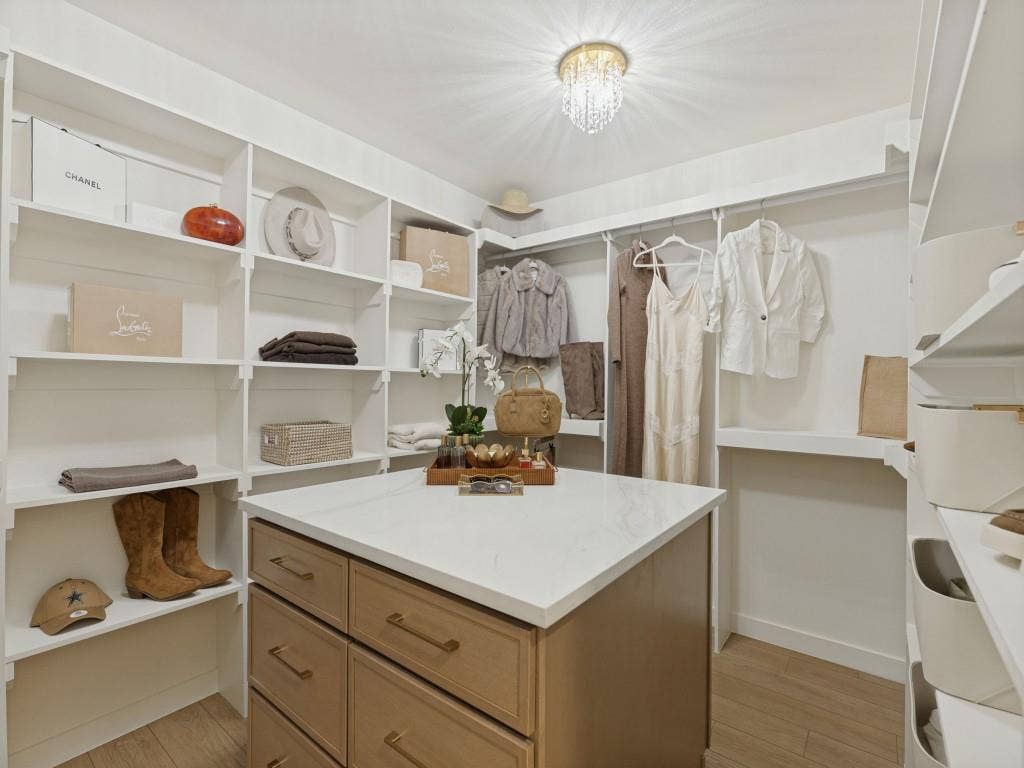 6029 Buffridge Trail, Dallas, TX 75252 Two walls for hanging clothes, a wall for folded clothes or handbags and a wall for shoes.