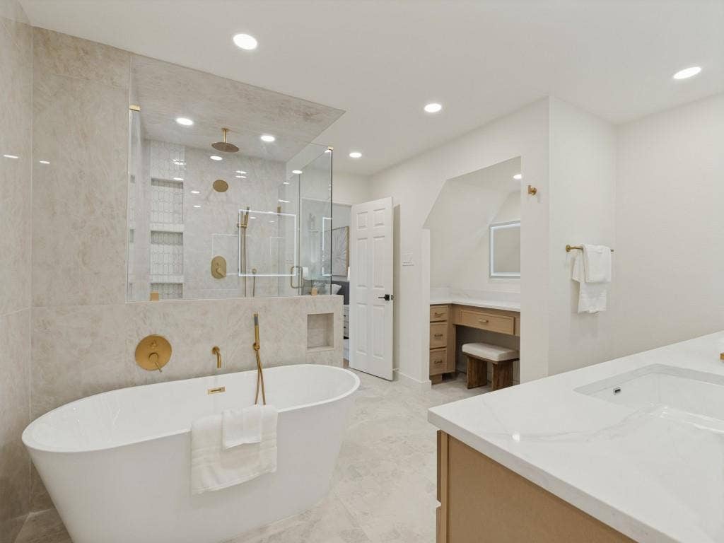 6029 Buffridge Trail, Dallas, TX 75252 Primary bathroom with oversized rain shower with custom glass enclosure and freestanding soaking tub