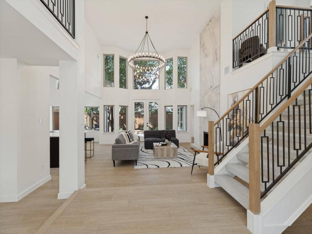 6029 Buffridge Trail, Dallas, TX 75252 This great room has 25 foot ceilings and no shortage of windows to enjoy the mature trees