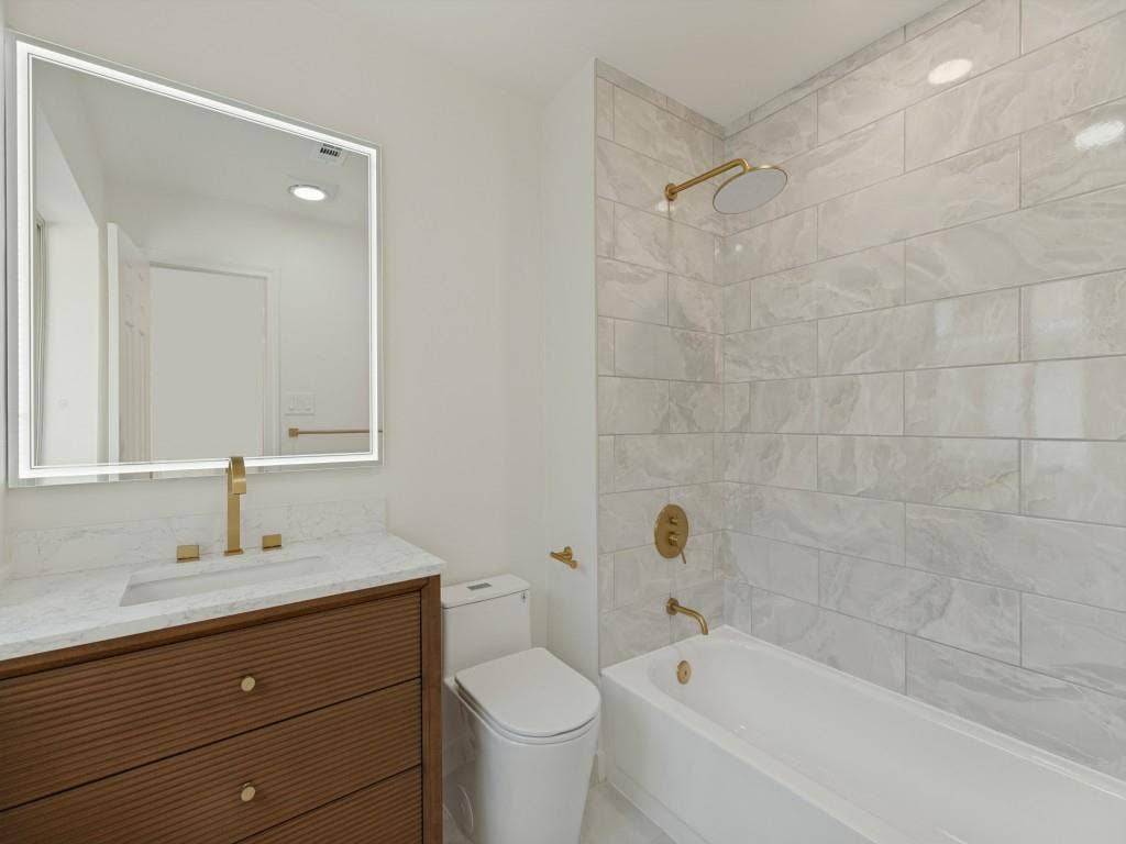 6029 Buffridge Trail, Dallas, TX 75252 Second floor full bathroom with new vanity, sink, faucet, LED mirror, modern toilet, tub surround, rain shower head and faucet, tub was re-glazed. No surface untouched!