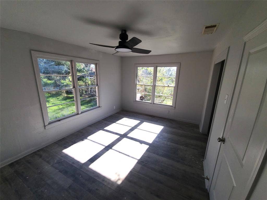 519 Dearborn Street, Waco, TX 76704 bedroom #4 with multiple windows, a ceiling fan, and dark wood finished floors