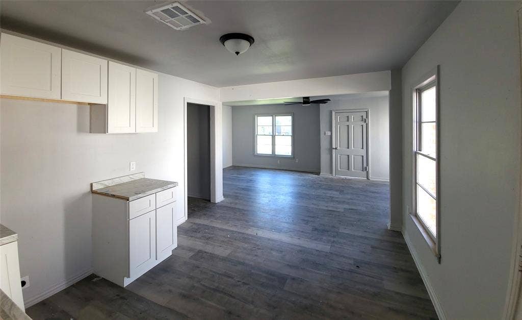 519 Dearborn Street, Waco, TX 76704 Kitchen with white cabinets, dark wood finished floors, ceiling fan, light countertops, and open floor plan