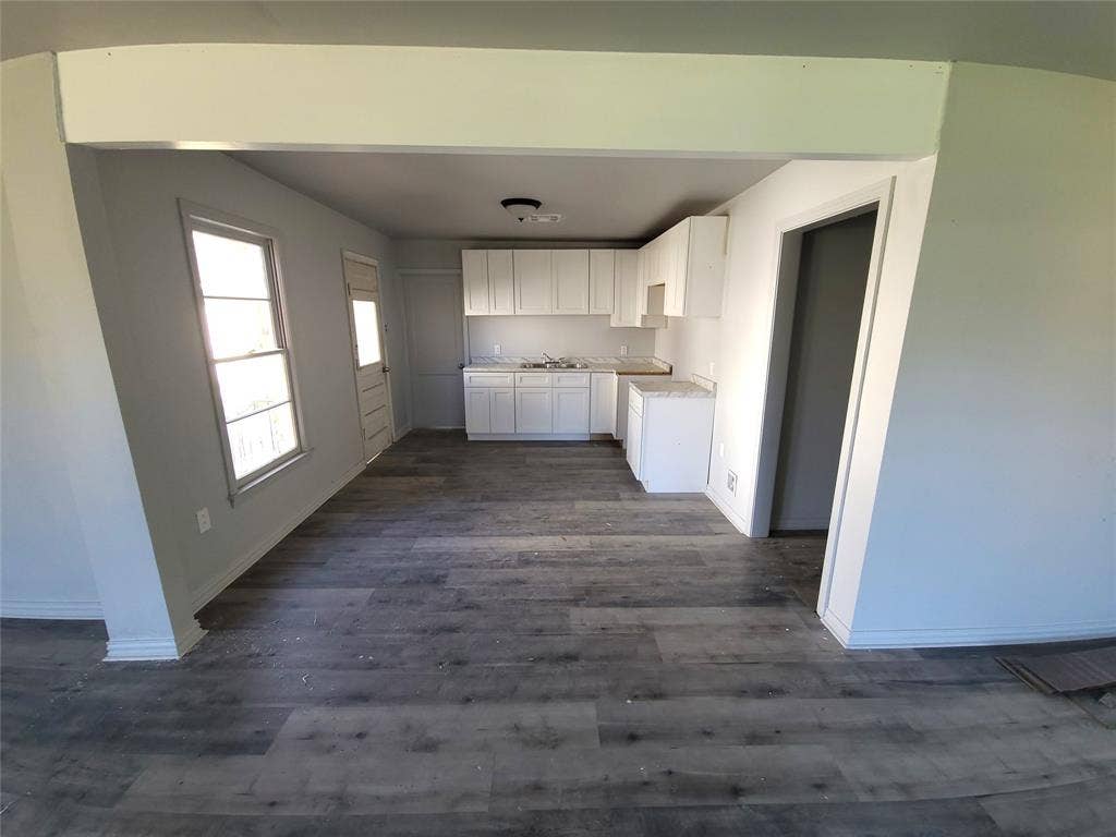 519 Dearborn Street, Waco, TX 76704 View into Open Concept Kitchen with white cabinetry, light countertops, and dark wood finished floors