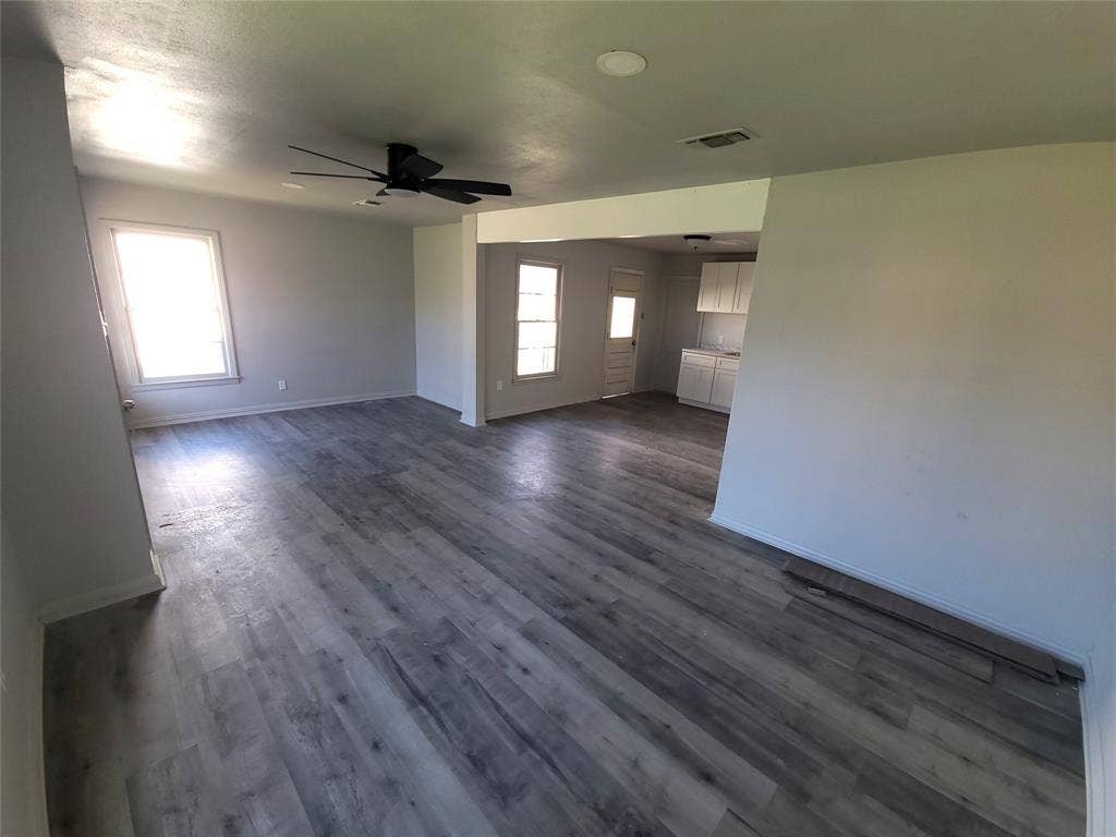519 Dearborn Street, Waco, TX 76704 living room / Dining Room featuring plenty of natural light, dark wood-type flooring, and a ceiling fan
