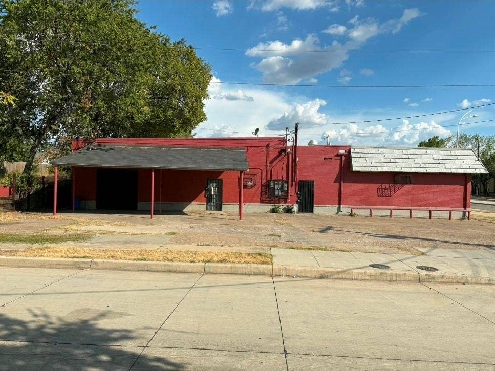 4606 Botham Jean Boulevard, Dallas, TX 75215 Red brick exterior with a flat roof section and an awning