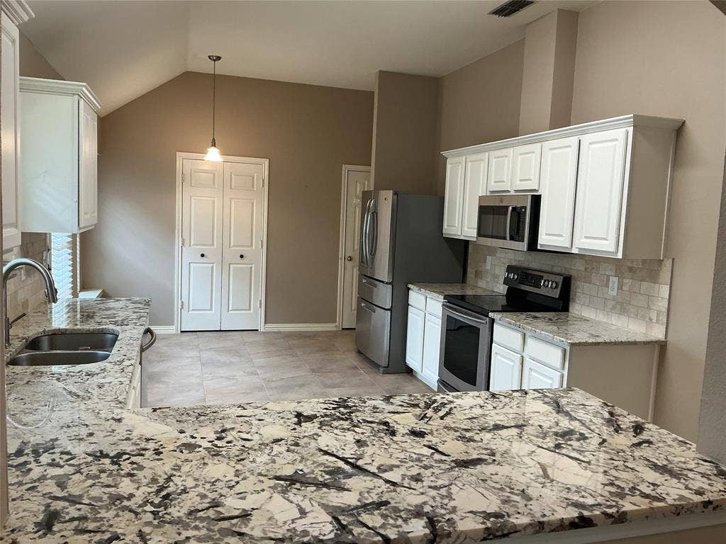 4005 Desert Mountain Drive, Plano, TX 75093 kitchen has a breafast nook with built in seating ledge