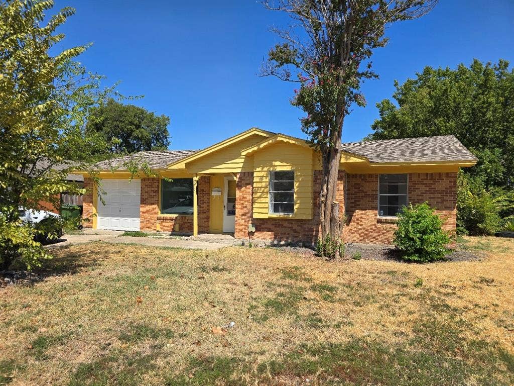 409 Monica Drive, Garland, TX 75041 Brick and siding exterior with a shingled roof, featuring a single-car garage and mature trees