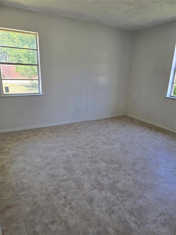 409 Monica Drive, Garland, TX 75041 Neutral tone wall finish and textured ceiling