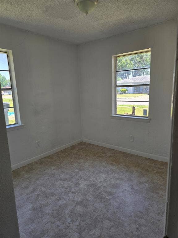 409 Monica Drive, Garland, TX 75041 White wall finishes and neutral-toned flooring