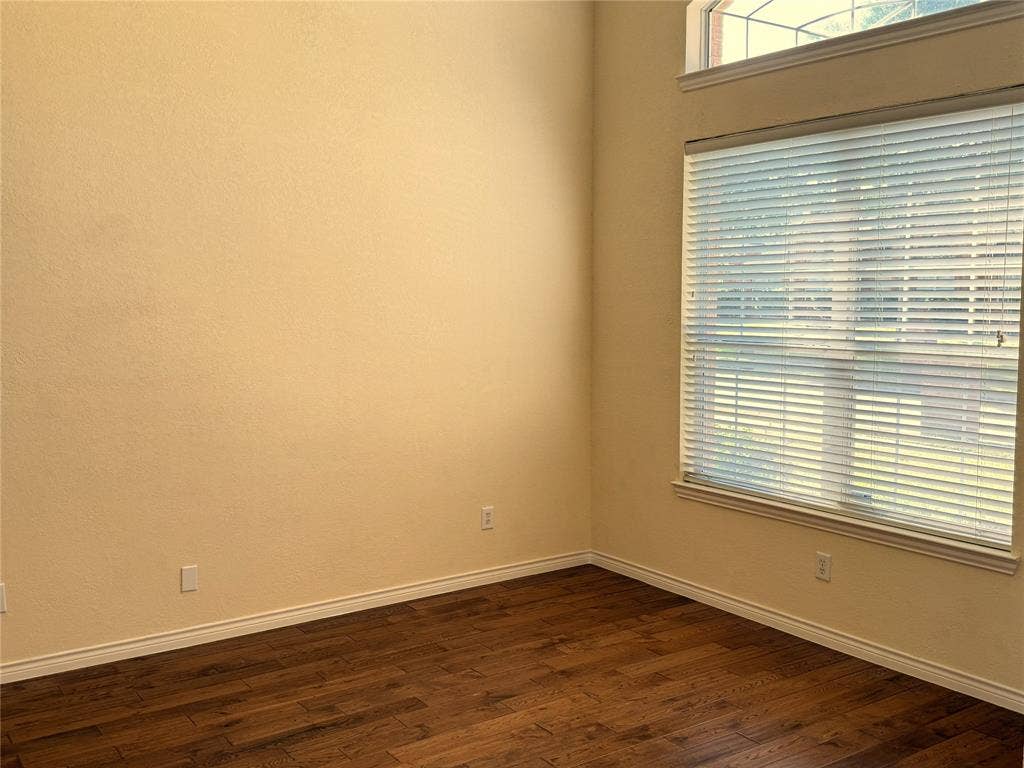 4413 Jenkins Drive, Plano, TX 75024 Wood-finish flooring, neutral wall paint, and a large window with white blinds
