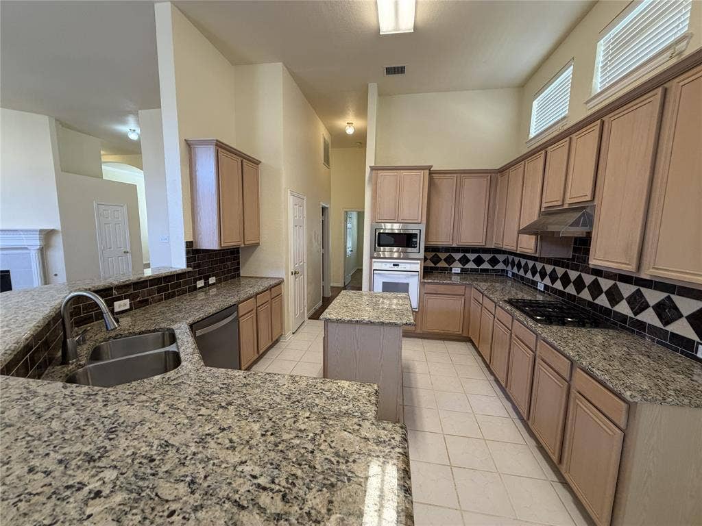 4413 Jenkins Drive, Plano, TX 75024 Spacious kitchen featuring extensive countertops, ample cabinetry, a built-in microwave, and an integrated gas cooktop