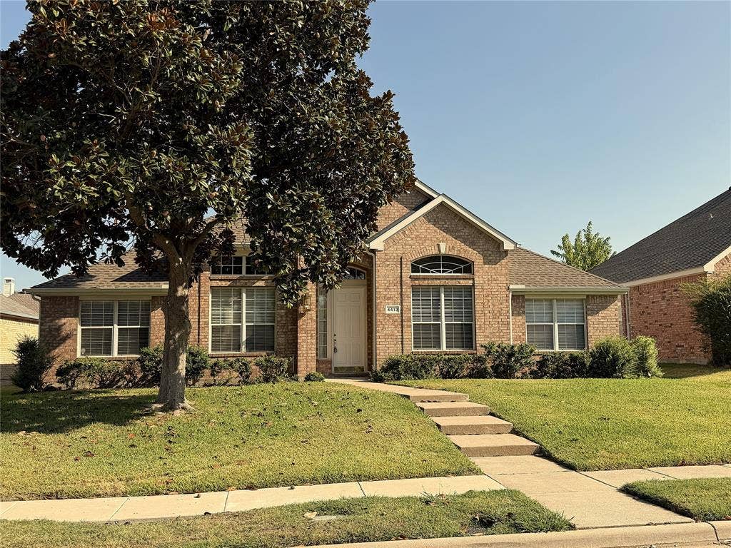 4413 Jenkins Drive, Plano, TX 75024 Brick exterior, gabled roofline, arched window detail, established landscaping, and a concrete walkway