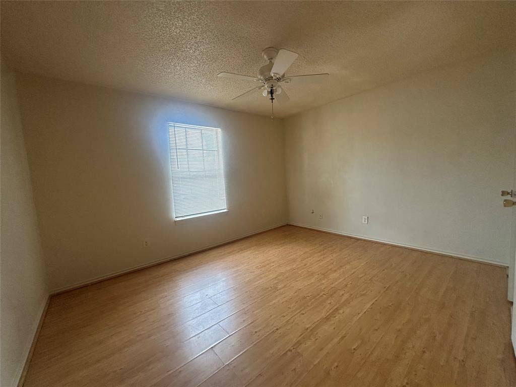1408 15th Place, #2, Plano, TX 75074 Wood-finish flooring, single window, and ceiling fan with integrated lighting