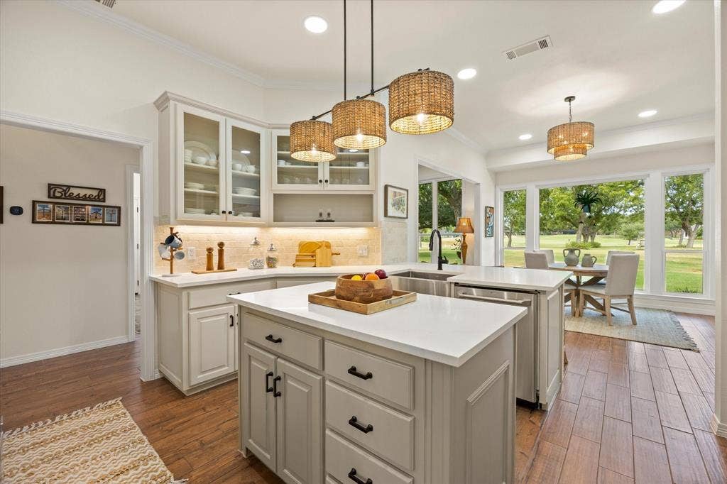 9604 Champions Drive, Granbury, TX 76049 Chef's Updated Kitchen Featuring New Quartz Counter Tops, Backsplash, Designer Paint Colors and Trending Light Fixtures