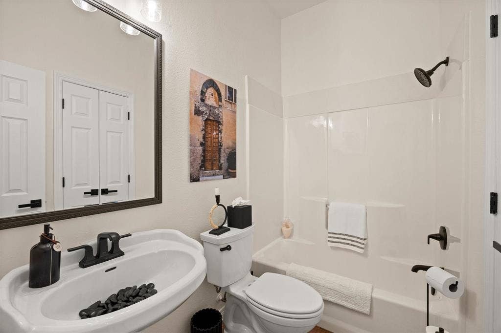 9604 Champions Drive, Granbury, TX 76049 Secondary Full Bathroom with Oversized Linen Closet, Kohler Fixtures, Framed Mirror and Updated Light Fixtures