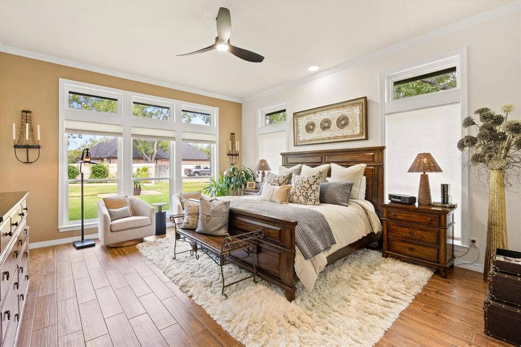 9604 Champions Drive, Granbury, TX 76049 Large Primary Bedroom with Wall of Windows and Designer Accent Wall Paint, Overlooks Landscaped Backyard and Golf Course