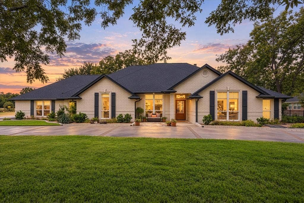 9604 Champions Drive, Granbury, TX 76049 Welcome Home! This Updated Home has it all! Features include New Flagstone Front Patio, Custom Shutters, Front Door, Uplighting, Landscaping and Designer Painted Brick Just to Name a Few. A Must See!