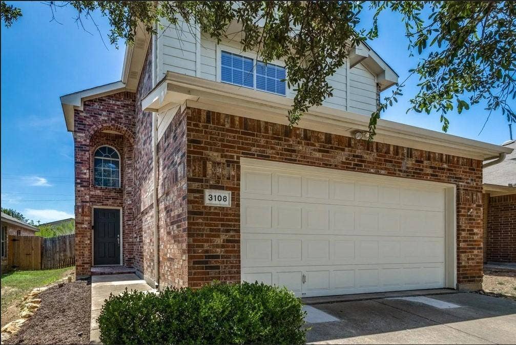 Brick-clad exterior with white siding accents