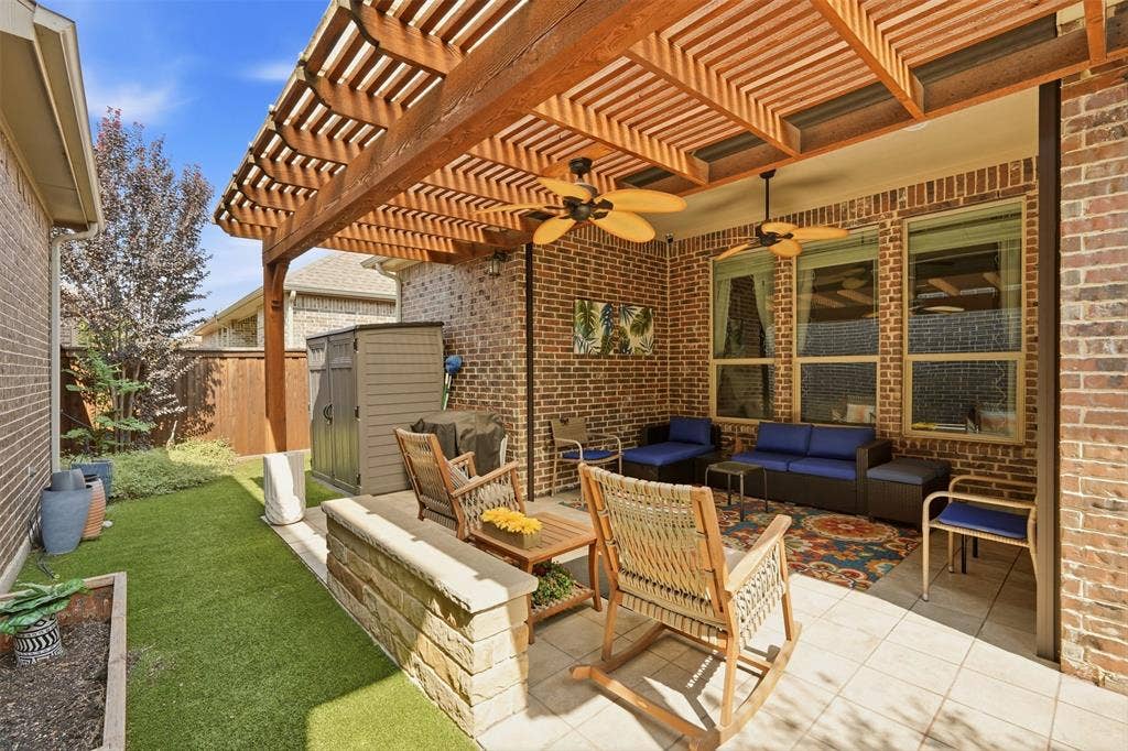 4808 Forest Crest Parkway, Arlington, TX 76005 Covered patio with a wood-tone pergola, brick exterior, ceiling fans, and tiled flooring