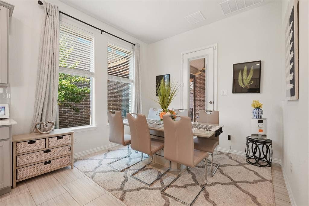 4808 Forest Crest Parkway, Arlington, TX 76005 Dining area featuring light-toned flooring, expansive windows with blinds, a built-in cabinet, and a door with a glass panel