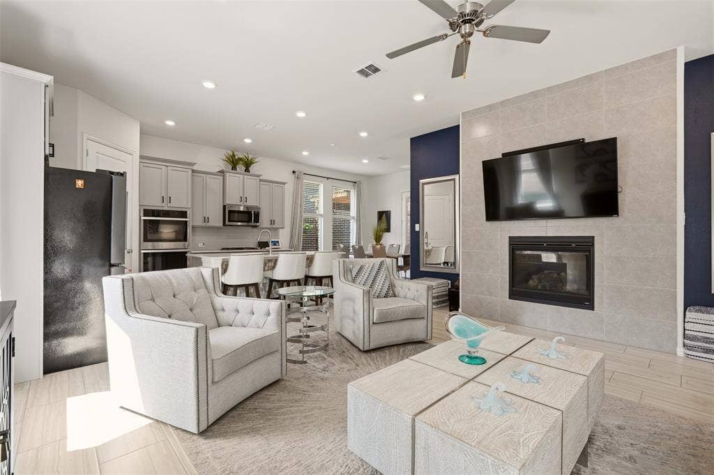 4808 Forest Crest Parkway, Arlington, TX 76005 Living area with a tiled fireplace, ceiling fan, and recessed lighting