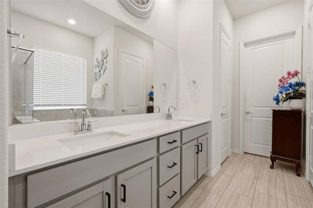 4808 Forest Crest Parkway, Arlington, TX 76005 Dual vanity with solid surface countertops, light gray cabinetry, and matte black hardware