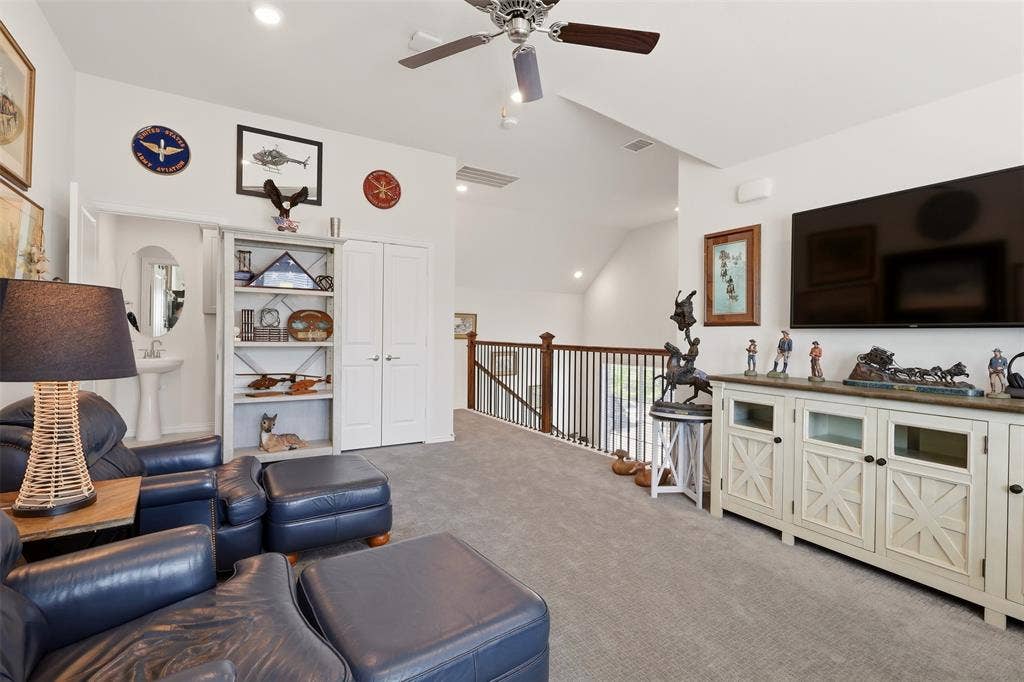 4808 Forest Crest Parkway, Arlington, TX 76005 Vaulted ceiling with a ceiling fan, recessed lighting, carpet flooring, wood-finish railing, and built-in shelving