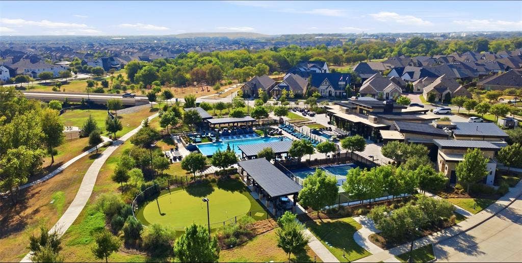 4808 Forest Crest Parkway, Arlington, TX 76005 Resort-style amenities featuring a large outdoor swimming pool, tennis court, putting green, and expansive community building with additional covered outdoor spaces, all surrounded by residential properties and mature landscaping