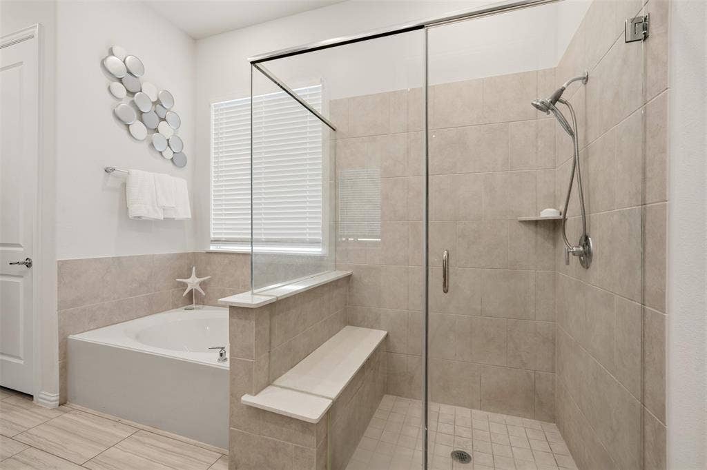 4808 Forest Crest Parkway, Arlington, TX 76005 Walk-in shower with clear glass enclosure, tiled walls, and a built-in bench