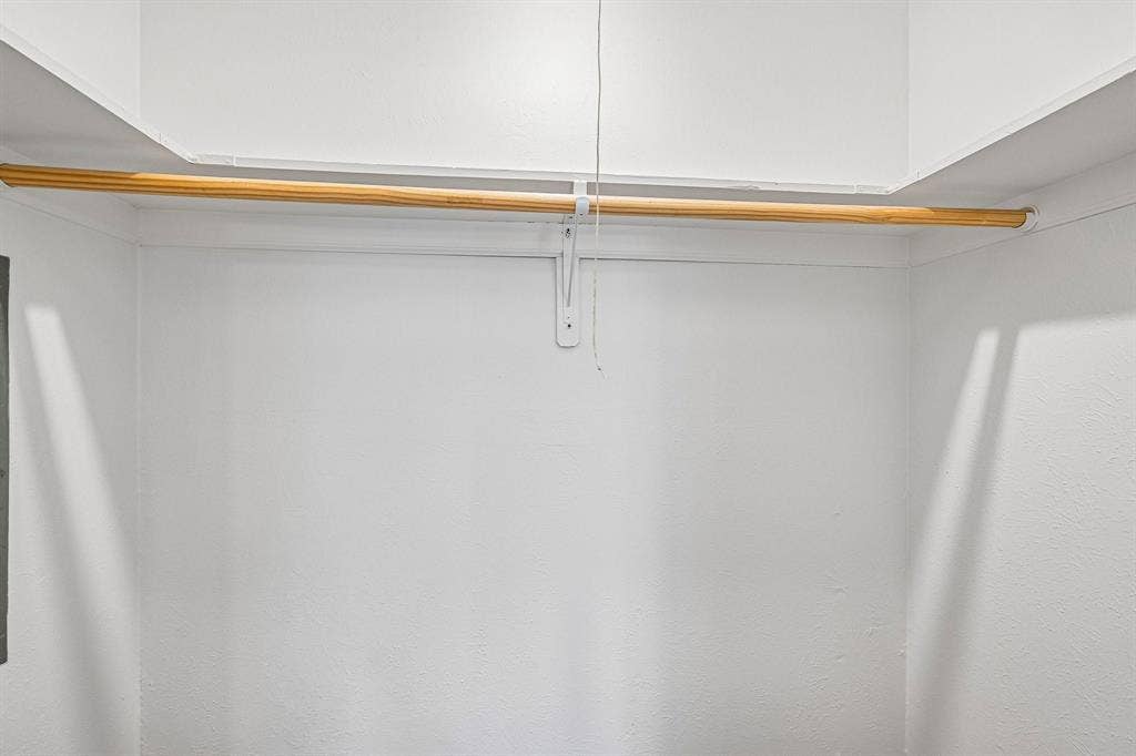 Recessed closet space with a built-in wooden hanging rod