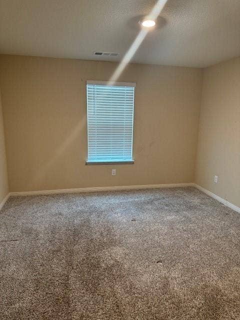 Recessed ceiling lighting, textured wall finish, window with horizontal blinds, and carpeted flooring