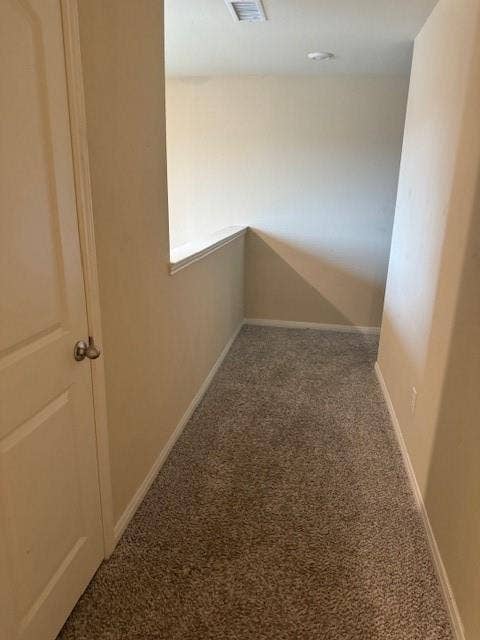 Neutral tone wall paint, textured carpeting, recessed ceiling lighting, and a white door with a round knob