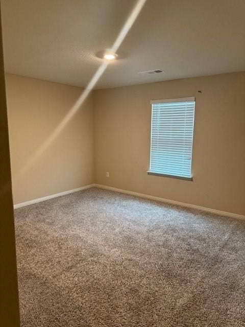 Carpeted flooring, recessed ceiling lighting, light-toned wall paint, white window blinds, and white trim molding