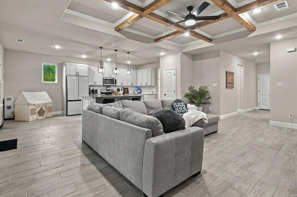 4822 Wichita Street, Granbury, TX 76048 Tray ceiling with exposed wood beams, ceiling fan, recessed lighting, wood-finish flooring, and light-toned walls