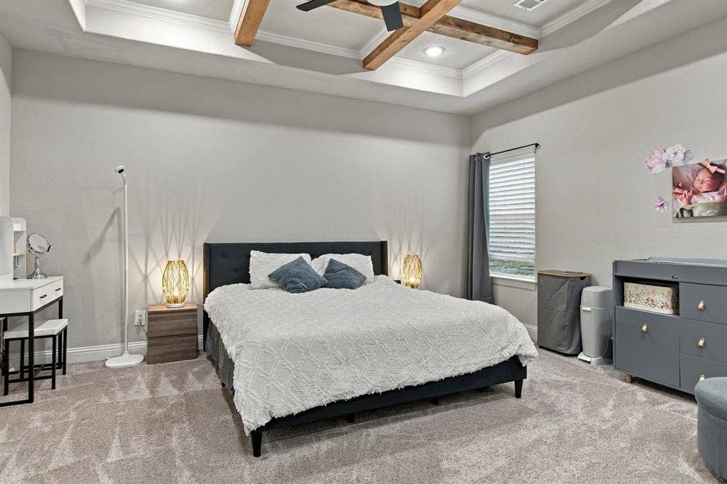 4822 Wichita Street, Granbury, TX 76048 Tray ceiling with wood-finish beams and a ceiling fan