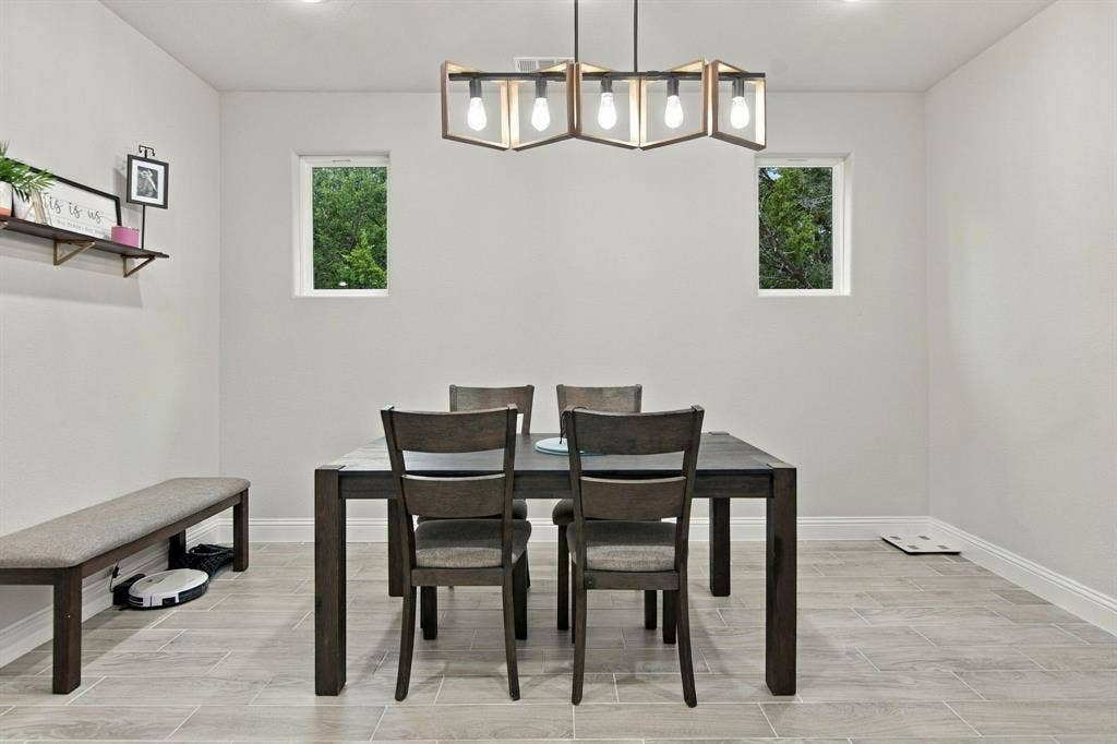 4822 Wichita Street, Granbury, TX 76048 Recessed lighting highlights a modern chandelier with exposed bulbs
